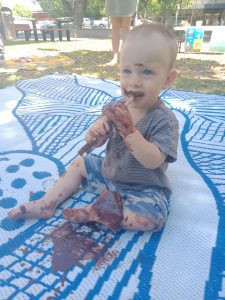 Baby eating "mud" paint