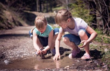 Two children playing in nature